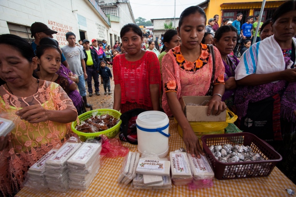 Women from the community of Raxruha sell their homemade chocolate bars during a campesino fair in Chisec. (WNV/Jeff Abbott)