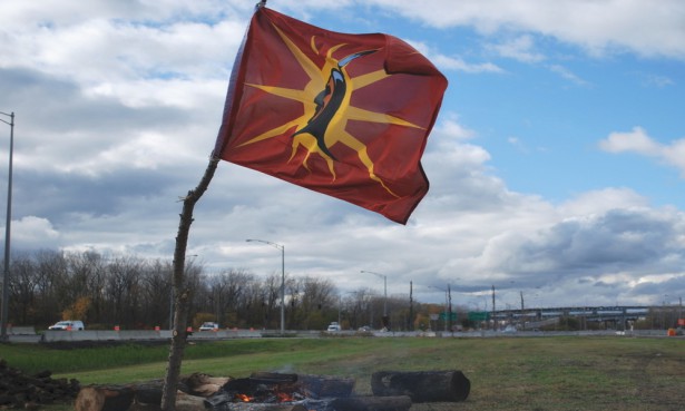 The Mohawk warrior flag flying next to the bonfire. (Red Power Media)