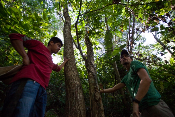 David Bautista (left), a member of the La Bendición youth group, shares the community's water source with a small group of volunteers from the United States while Lucas Wolf from the organization Trees, Water, People, translates. (WNV/Jeff Abbott)