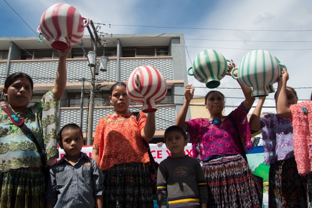 Women carried inverted water containers to symbolize the loss of access to the water of the river during a march in Guatemala City on Oct. 17. (WNV/)