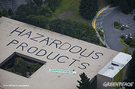 Greenpeace activists sit in protest after painting "Hazardous Products" on the roof of Hewlett Packard headquarters in Palo Alto, Calif., July 28, 2009.  Greenpeace exposed electronics giant Hewlett Packard for backtracking on its public commitment to eliminate key toxic chemicals in its products by the end of this year. The message, applied using non-toxic children's finger-paint, covered more than 11,500 square feet, or the size of two and half basketball courts.