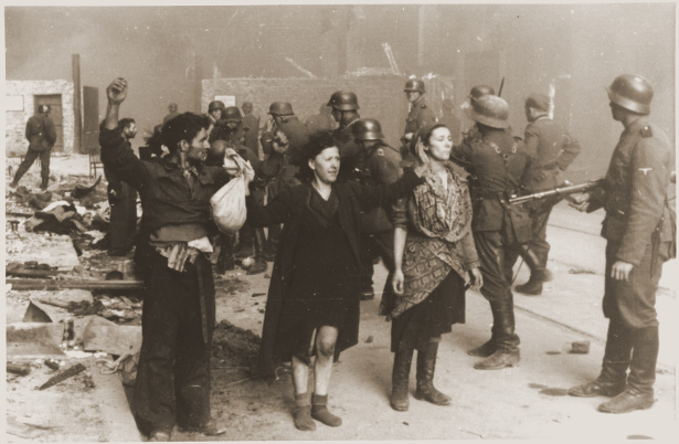 SS troops guard members of the Jewish resistance captured during the suppression of the Warsaw ghetto uprising. (US Holocaust Memorial Museum)