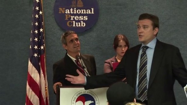 Andy Bichlbaum of the Yes Men (left) poses as U.S. Chamber of Commerce representative much to the chagrin of the real Chamber representative. (Vimeo / The Yes Men)