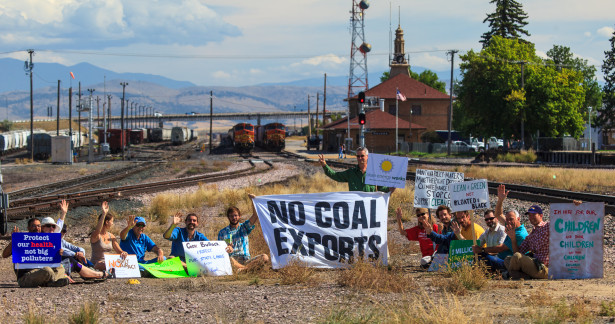 The 14 protesters who shut down the main coal export rail line to the West Coast pose before being arrested. (WNV / Jeff Vantine)