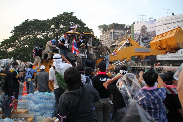 Protesters seize a bulldozer in an attempt to plow through police barricades outside Government House last month. (WNV/Mark Fenn)