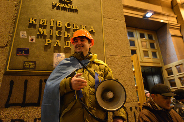 An activist stands with a bullhorn outside Kiev's City Council, which was taken over by the opposition on December 1, 2013. (Flickr/Ivan Bandura)