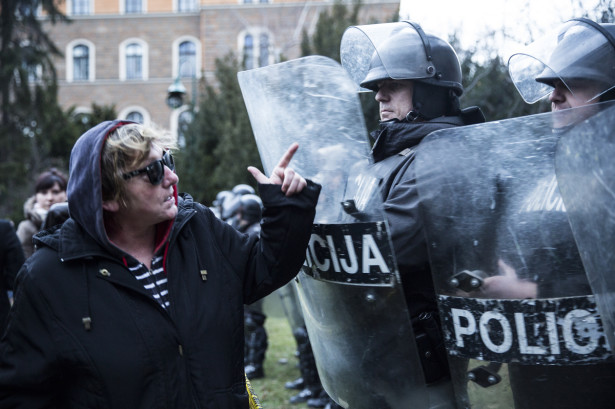Protesters argue with police in Sarajevo on February 8, 2014, outside the city's municipal building. It sustained heavy damage after protesters attacked and set fire to it. (WNV/Jodi Hilton)