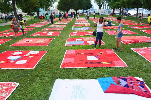 Monument Quilt laid out crowd-sourced quilts with messages about domestic violence or sexual assault in Baltimore in August 2014. (Monument Quilt) 