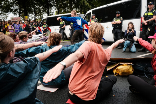 Activists perform yoga as they block the A12