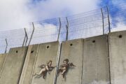 Angels break open the West Bank separation wall using a crowbar