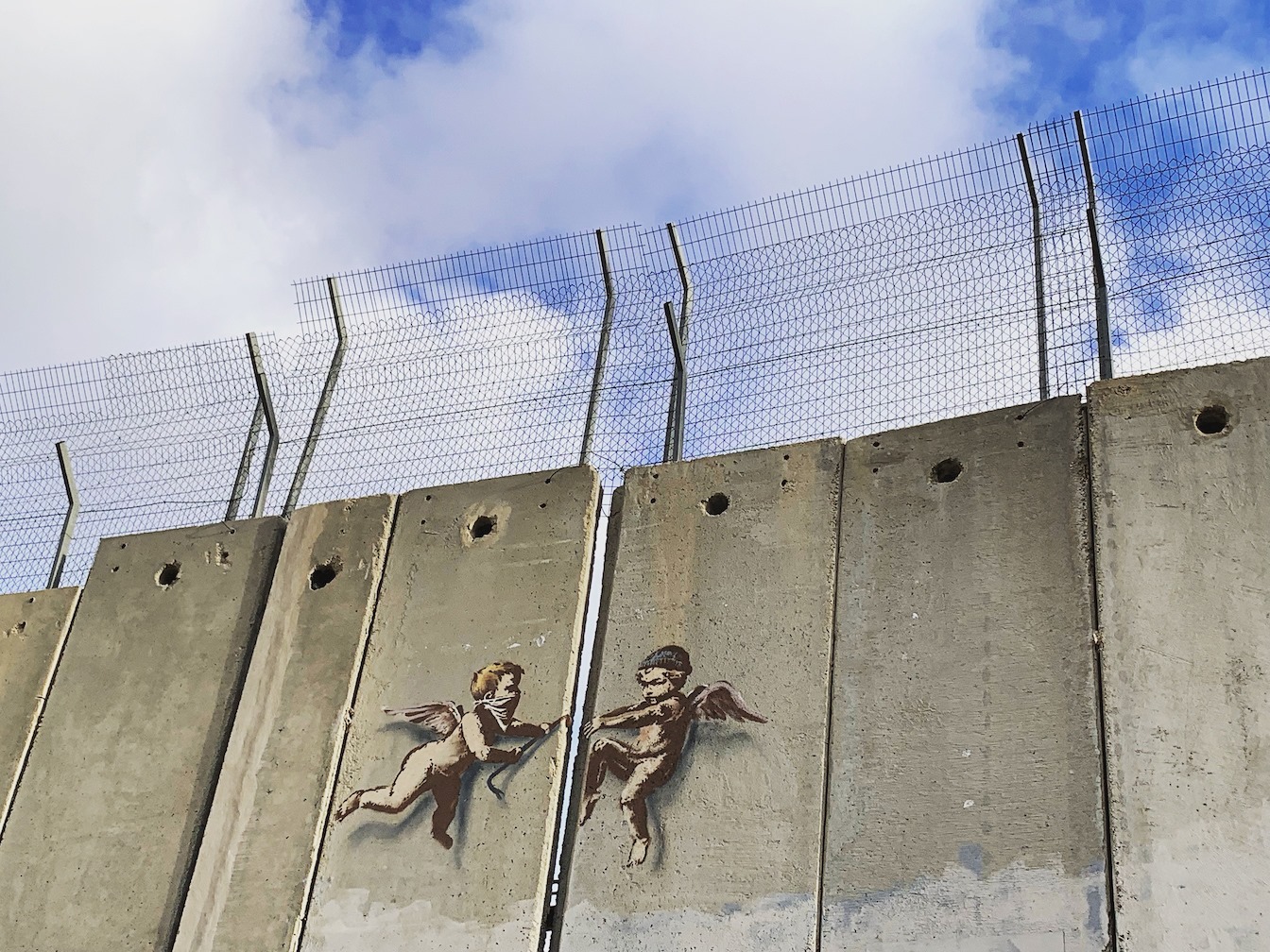 Angels break open the West Bank separation wall using a crowbar