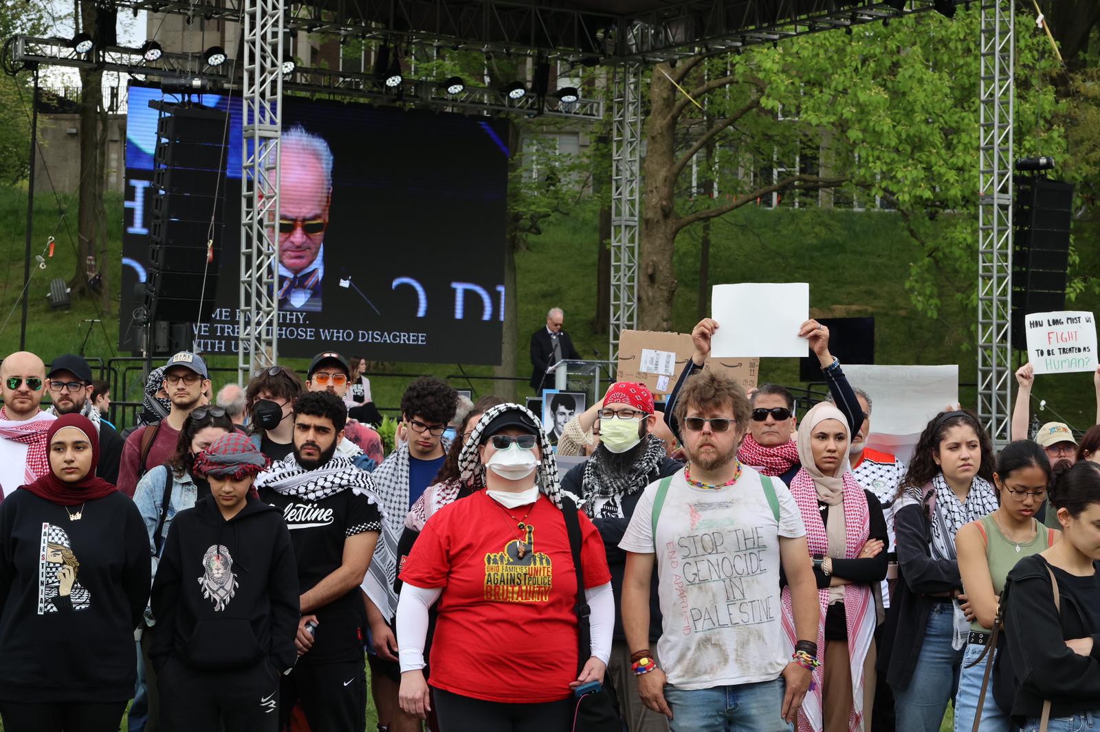 Protesters turn their back on university President Todd Diacon during his speech at the May 4th commemoration.