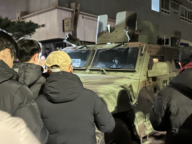 Citizens blocking military vehicles advancing toward the National Assembly in Yeouido