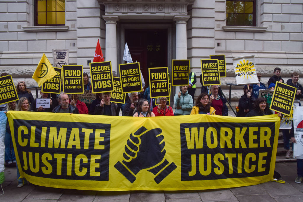 Protesters call for investments in green jobs and clean energy outside the Treasury in London on October 9, 2024.