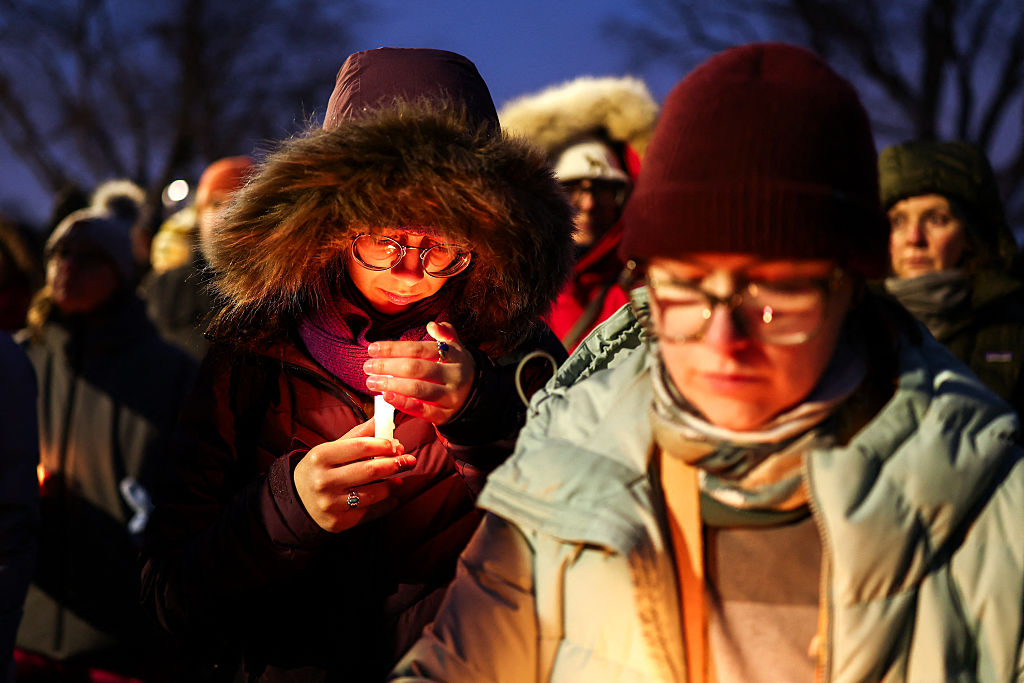 People gather for a candlelight vigil for Alex Pretti, who was shot and killed by federal agents in Minneapolis, Minnesota on January 124 2026. (CHARLY TRIBALLEAU / AFP via Getty Images)