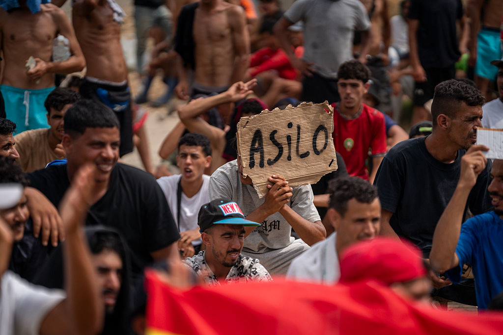 Migrants gather in a protest asking for asylum in El Trampol&iacute;n beach on August 16, 2026 in Ceuta. (Adri Salido/Getty Images)